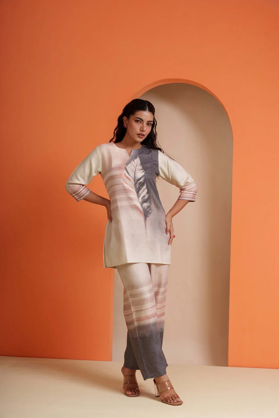Woman in elegant viscose co-ord set with feather print, perfect for parties and festive occasions