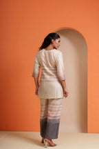 Woman in elegant striped co-ord set with gradient pants, perfect for festive occasions and parties.
