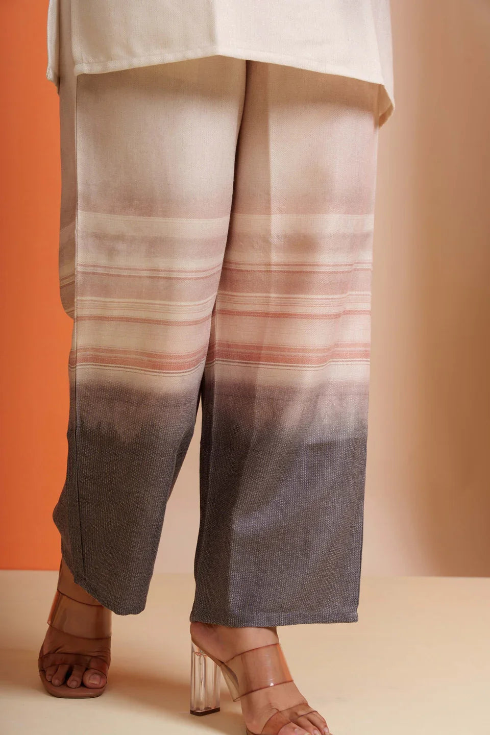 Wide-leg gradient pants with striped pattern, soft viscose fabric, styled with heels for modern women's wear