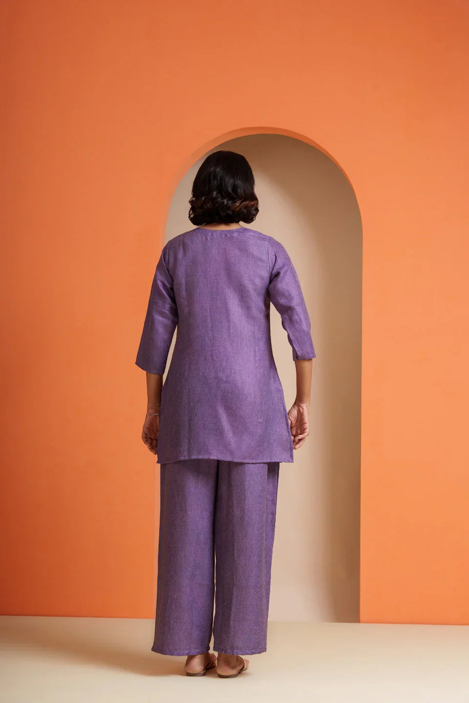 Purple viscose co-ord set with tunic and wide-leg pants, back view against orange arch