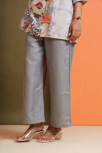 Grey wide-leg pants with abstract print top, styled for modern everyday wear or festive occasions.