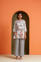 Woman in artistic print tunic and grey palazzo pants, stylish co-ord set for casual or festive wear