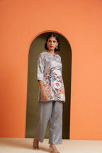 Woman in printed viscose tunic and grey pants, modern co-ord set for casual or festive wear