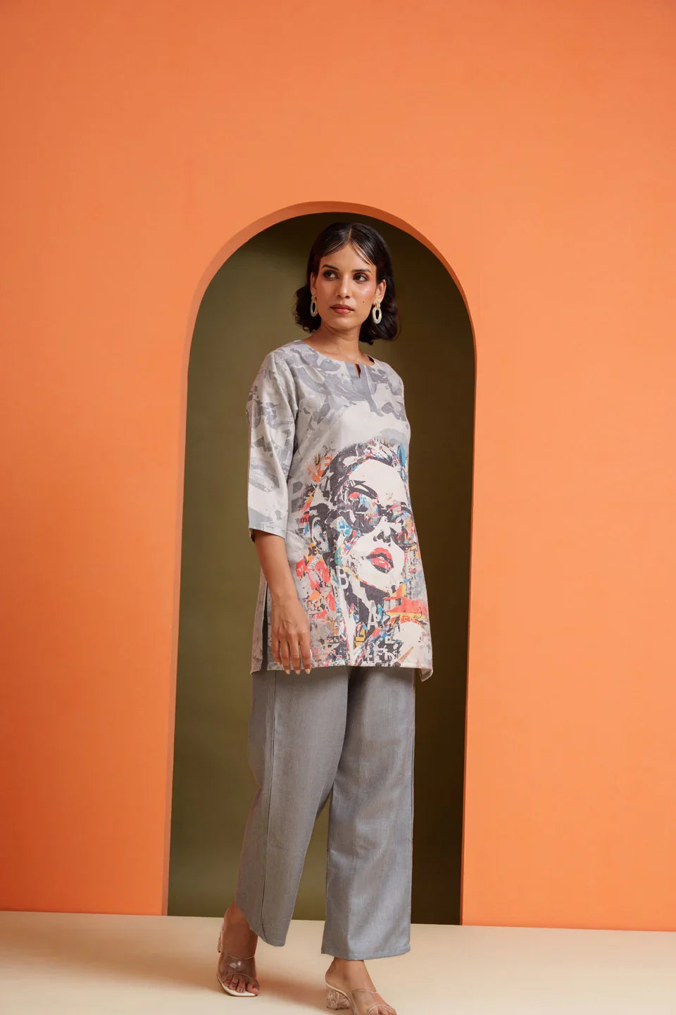 Woman in printed viscose tunic and grey pants, modern co-ord set for casual or festive wear